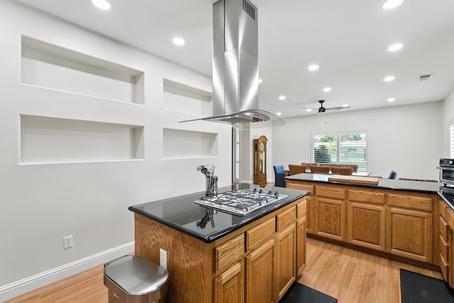 135 N Park Dr, Madera, CA 93637 - kitchen featuring island exhaust hood, dark countertops, ceiling fan, a center island, and recessed lighting
