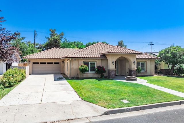 135 N Park Dr, Madera, CA 93637 - mediterranean / spanish home with stucco siding, a tile roof, a garage, and driveway