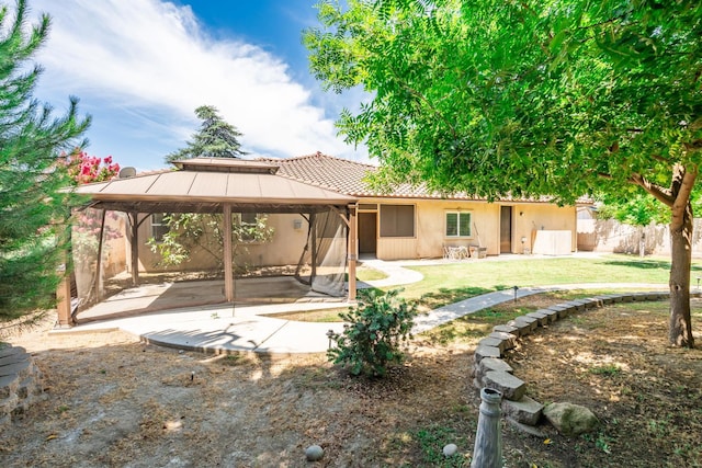 135 N Park Dr, Madera, CA 93637 - rear view of property with a gazebo, a patio area, a yard, stucco siding, and a tiled roof