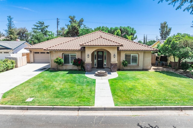 135 N Park Dr, Madera, CA 93637 - mediterranean / spanish-style house featuring stucco siding, a tiled roof, concrete driveway, and a garage