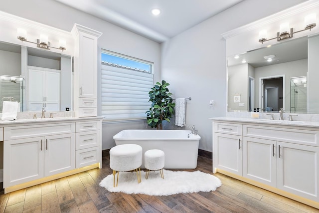 2706 Trenton Ave, Clovis, CA 93619 - bathroom featuring a stall shower, two vanities, and wood-type flooring