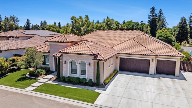 2706 Trenton Ave, Clovis, CA 93619 - mediterranean / spanish home with an attached garage, a tiled roof, driveway, stone siding, and stucco siding