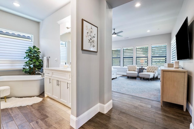 2706 Trenton Ave, Clovis, CA 93619 - full bath featuring a freestanding tub, vanity, healthy amount of natural light, wood-type flooring, and recessed lighting