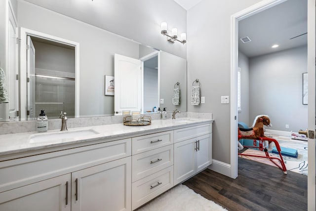 2706 Trenton Ave, Clovis, CA 93619 - full bath featuring double vanity, wood finished floors, and a shower stall