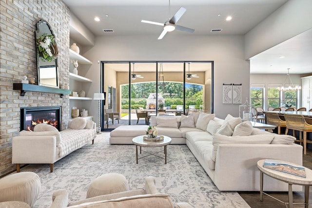 2706 Trenton Ave, Clovis, CA 93619 - living area featuring a ceiling fan, a towering ceiling, a fireplace, recessed lighting, and a chandelier