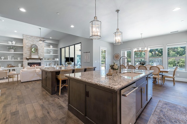 2706 Trenton Ave, Clovis, CA 93619 - kitchen with a kitchen island with sink, dishwasher, a large fireplace, dark wood finished floors, and recessed lighting