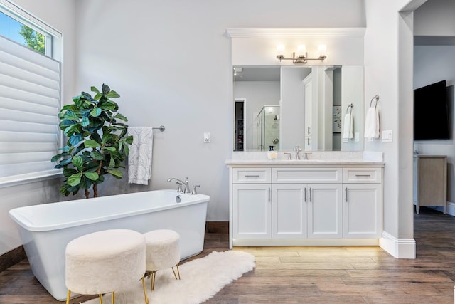 2706 Trenton Ave, Clovis, CA 93619 - bathroom featuring vanity, a stall shower, a soaking tub, and wood finished floors