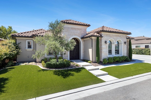 2706 Trenton Ave, Clovis, CA 93619 - mediterranean / spanish house with stone siding, a tile roof, a front yard, and stucco siding