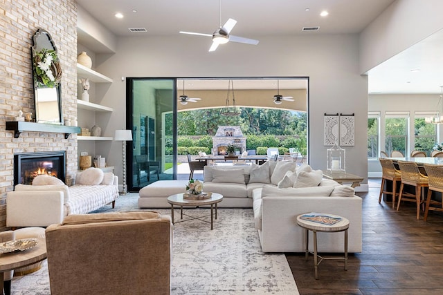 2706 Trenton Ave, Clovis, CA 93619 - living room with ceiling fan, wood-type flooring, a towering ceiling, built in features, and a brick fireplace