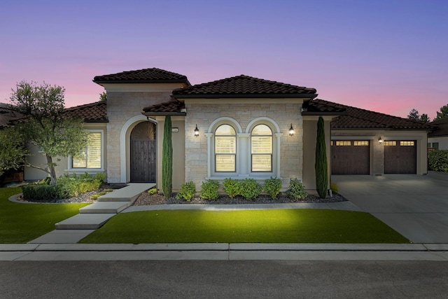 2706 Trenton Ave, Clovis, CA 93619 - mediterranean / spanish home with a tile roof, a garage, concrete driveway, stone siding, and a front lawn