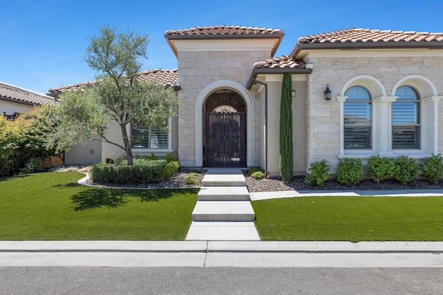 2706 Trenton Ave, Clovis, CA 93619 - view of front of home with stone siding, a tiled roof, a front yard, and stucco siding