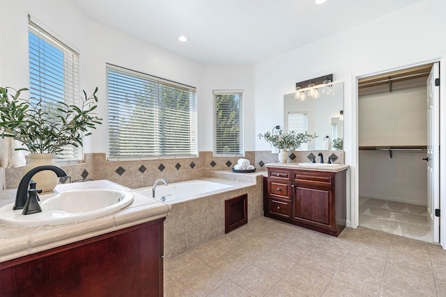 4160 N Creekbend, Clovis, CA 93619 - full bath with two vanities, a garden tub, tile patterned floors, a walk in closet, and recessed lighting