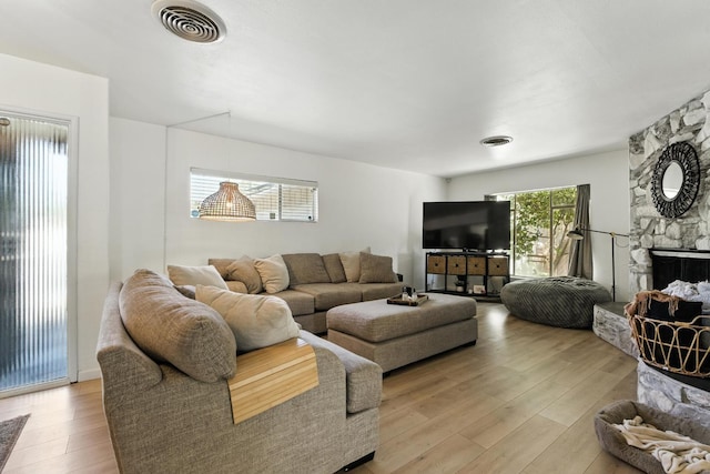 4678 N Thorne Ave, Fresno, CA 93704 - living room with light wood-style floors and a fireplace