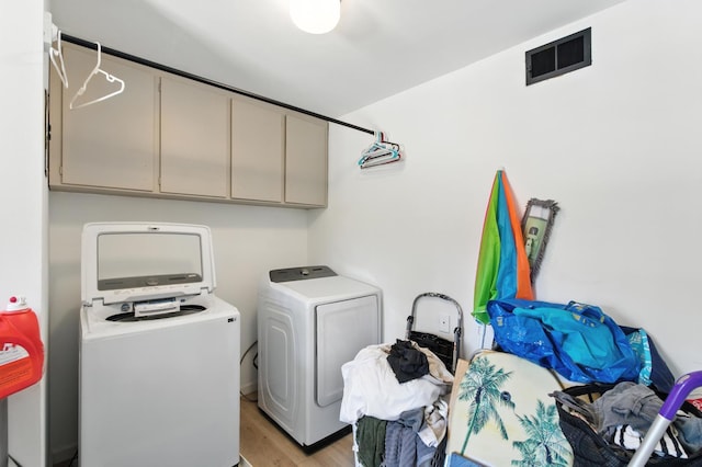 4678 N Thorne Ave, Fresno, CA 93704 - laundry room featuring cabinet space, washing machine and dryer, and light wood-style floors