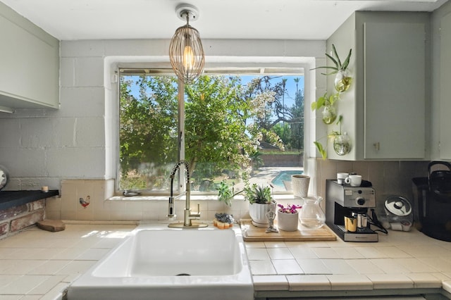 4678 N Thorne Ave, Fresno, CA 93704 - kitchen featuring tile counters and backsplash