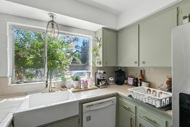 4678 N Thorne Ave, Fresno, CA 93704 - kitchen featuring white dishwasher, freestanding refrigerator, tasteful backsplash, green cabinets, and tile countertops