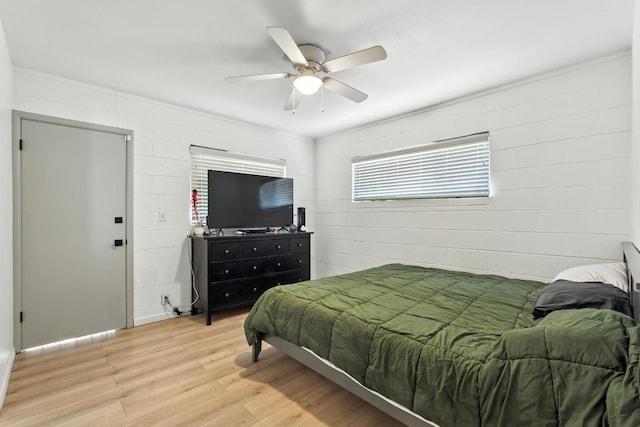 4678 N Thorne Ave, Fresno, CA 93704 - bedroom with light wood-type flooring, concrete block wall, and ceiling fan
