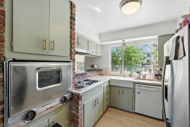 4678 N Thorne Ave, Fresno, CA 93704 - kitchen featuring dishwasher, fridge with ice dispenser, stainless steel electric cooktop, light countertops, and light wood-style flooring