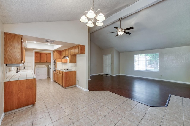 6283 N Gilroy Ave, Fresno, CA 93722 - kitchen with ceiling fan, tile countertops, light tile patterned floors, backsplash, and oven