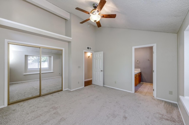 6283 N Gilroy Ave, Fresno, CA 93722 - unfurnished bedroom featuring vaulted ceiling, light colored carpet, a textured ceiling, a closet, and ceiling fan