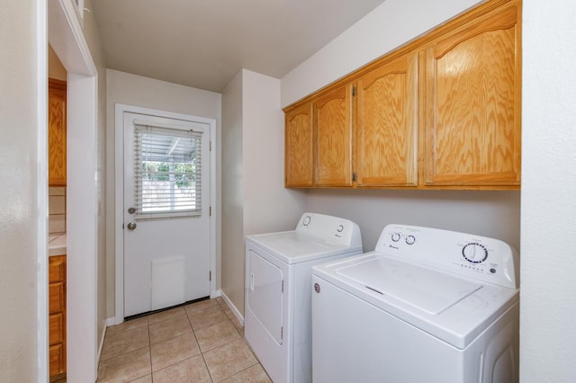 6283 N Gilroy Ave, Fresno, CA 93722 - laundry room featuring washing machine and clothes dryer, cabinet space, and light tile patterned flooring