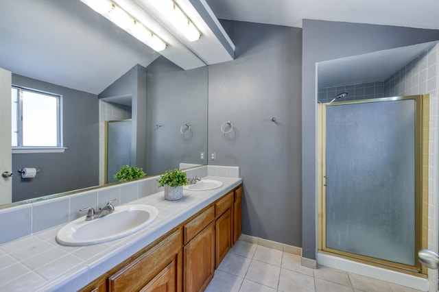 6283 N Gilroy Ave, Fresno, CA 93722 - bathroom featuring double vanity, a shower stall, lofted ceiling, and tile patterned floors