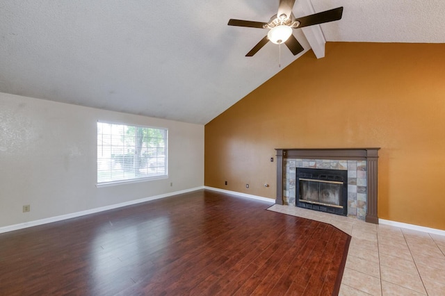 6283 N Gilroy Ave, Fresno, CA 93722 - unfurnished living room with a tile fireplace, ceiling fan, a textured ceiling, and wood finished floors