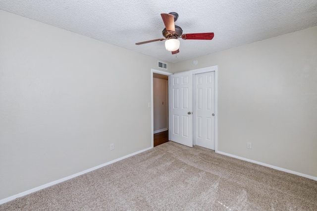 6283 N Gilroy Ave, Fresno, CA 93722 - unfurnished bedroom featuring light carpet, a closet, a ceiling fan, and a textured ceiling