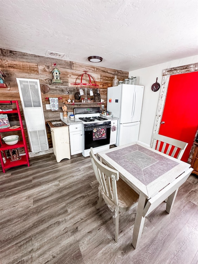 37969 Rd 422, Oakhurst, CA 93644 - kitchen featuring gas range, freestanding refrigerator, dark wood-style floors, a textured ceiling, and light countertops