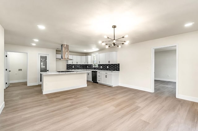 2643 B St, Selma, CA 93662 - kitchen featuring island range hood, black appliances, a chandelier, light countertops, and decorative backsplash