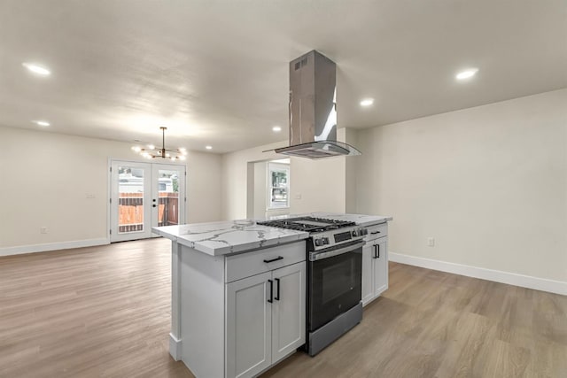 2643 B St, Selma, CA 93662 - kitchen featuring stainless steel range with gas stovetop, island exhaust hood, light wood-style flooring, a center island, and recessed lighting