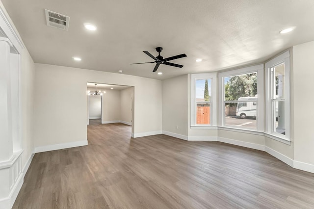 2643 B St, Selma, CA 93662 - spare room featuring a chandelier, wood finished floors, ceiling fan, and recessed lighting