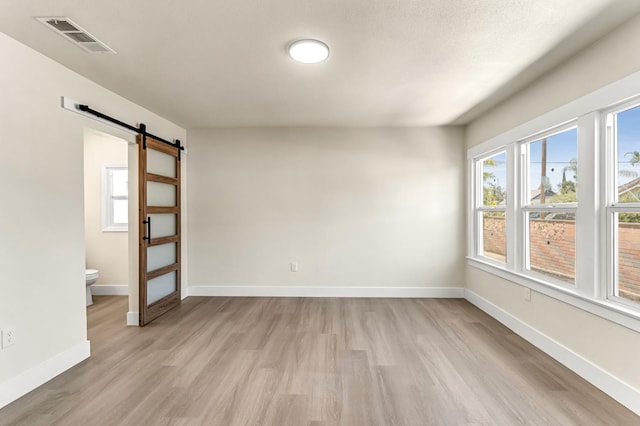 2643 B St, Selma, CA 93662 - spare room featuring a barn door and light wood-style flooring