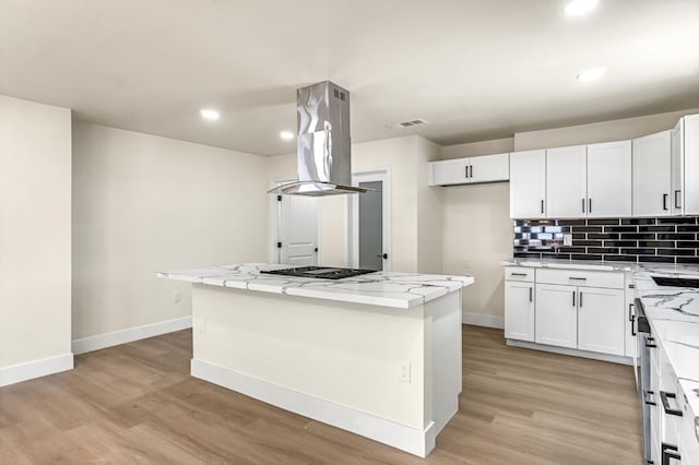 2643 B St, Selma, CA 93662 - kitchen with island range hood, light wood finished floors, a kitchen island, light stone countertops, and recessed lighting