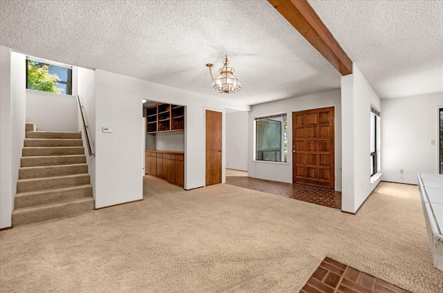 835 E Ashcroft Ave, Fresno, CA 93704 - unfurnished living room with carpet floors, a textured ceiling, a chandelier, and stairway