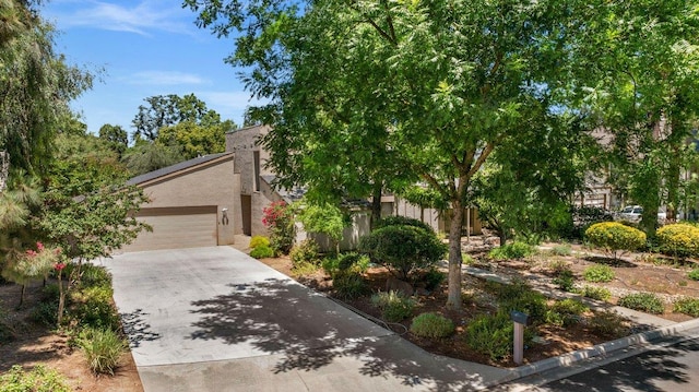 835 E Ashcroft Ave, Fresno, CA 93704 - view of front facade with concrete driveway, an attached garage, and stucco siding