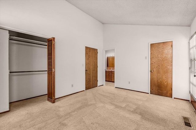 835 E Ashcroft Ave, Fresno, CA 93704 - unfurnished bedroom with vaulted ceiling, carpet floors, and a textured ceiling