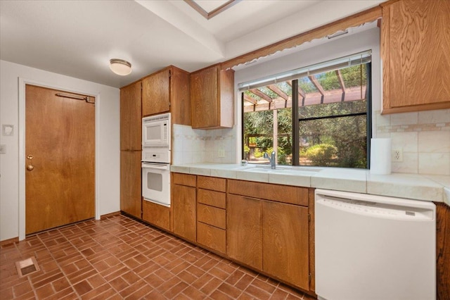 835 E Ashcroft Ave, Fresno, CA 93704 - kitchen featuring white appliances, brick patterned floors, backsplash, and tile counters