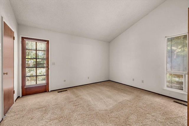 835 E Ashcroft Ave, Fresno, CA 93704 - unfurnished room with vaulted ceiling, carpet, and a textured ceiling