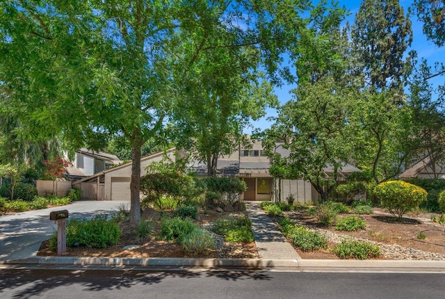 835 E Ashcroft Ave, Fresno, CA 93704 - obstructed view of property with concrete driveway, a garage, and stucco siding