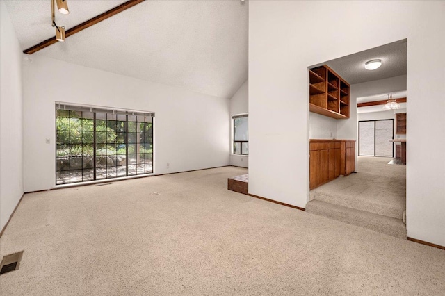 835 E Ashcroft Ave, Fresno, CA 93704 - unfurnished living room with carpet flooring, high vaulted ceiling, and beamed ceiling