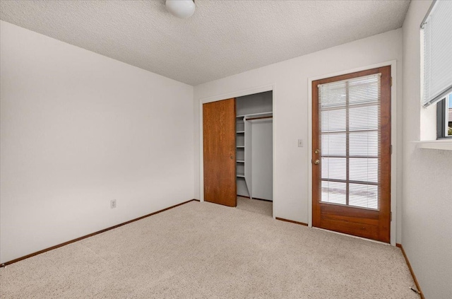 835 E Ashcroft Ave, Fresno, CA 93704 - unfurnished bedroom with multiple windows, light carpet, a closet, and a textured ceiling