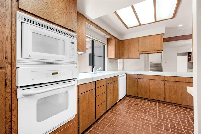 835 E Ashcroft Ave, Fresno, CA 93704 - kitchen featuring white appliances, brick patterned floors, brown cabinets, and recessed lighting
