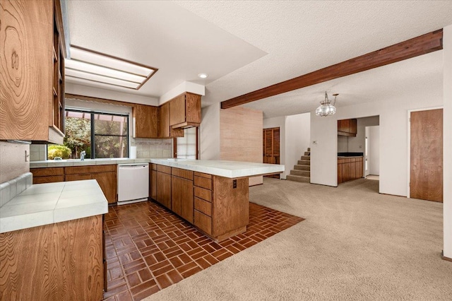 835 E Ashcroft Ave, Fresno, CA 93704 - kitchen with white dishwasher, brown cabinets, a peninsula, beam ceiling, and open floor plan