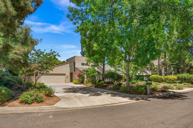 835 E Ashcroft Ave, Fresno, CA 93704 - view of front of house featuring concrete driveway, an attached garage, and stucco siding
