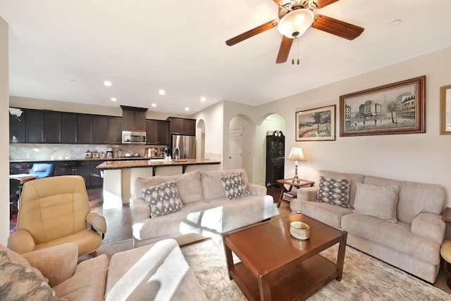 11319 N Via Napoli Dr, Fresno, CA 93730 - living room with arched walkways, a ceiling fan, and recessed lighting