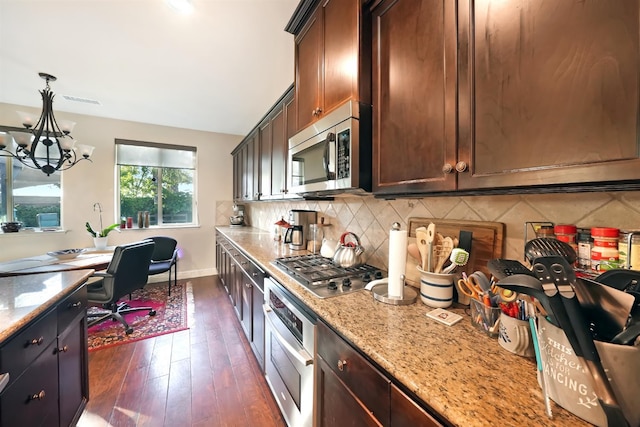11319 N Via Napoli Dr, Fresno, CA 93730 - kitchen with appliances with stainless steel finishes, a chandelier, backsplash, dark wood-style floors, and decorative light fixtures