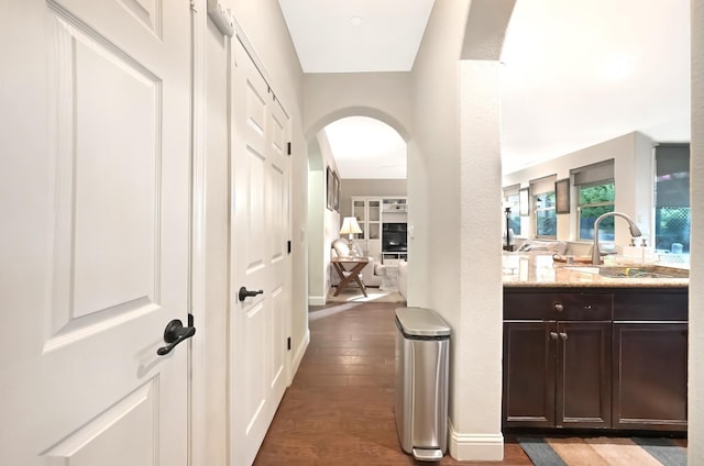 11319 N Via Napoli Dr, Fresno, CA 93730 - hall featuring arched walkways and dark wood-type flooring