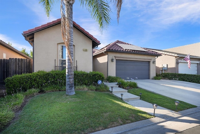 11319 N Via Napoli Dr, Fresno, CA 93730 - mediterranean / spanish house with roof mounted solar panels, driveway, stucco siding, and a garage