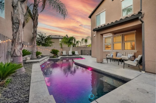 11617 N Bella Verde Ave, Fresno, CA 93730 - pool at dusk featuring a patio area, an outdoor hangout area, and a fenced backyard